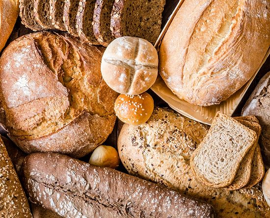 A wide variety of different bread types, including sliced bread, buns and more